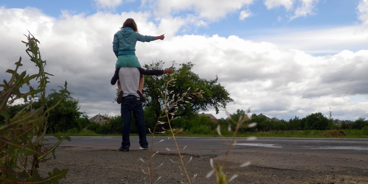 Hitchhiking on the road with a backpack